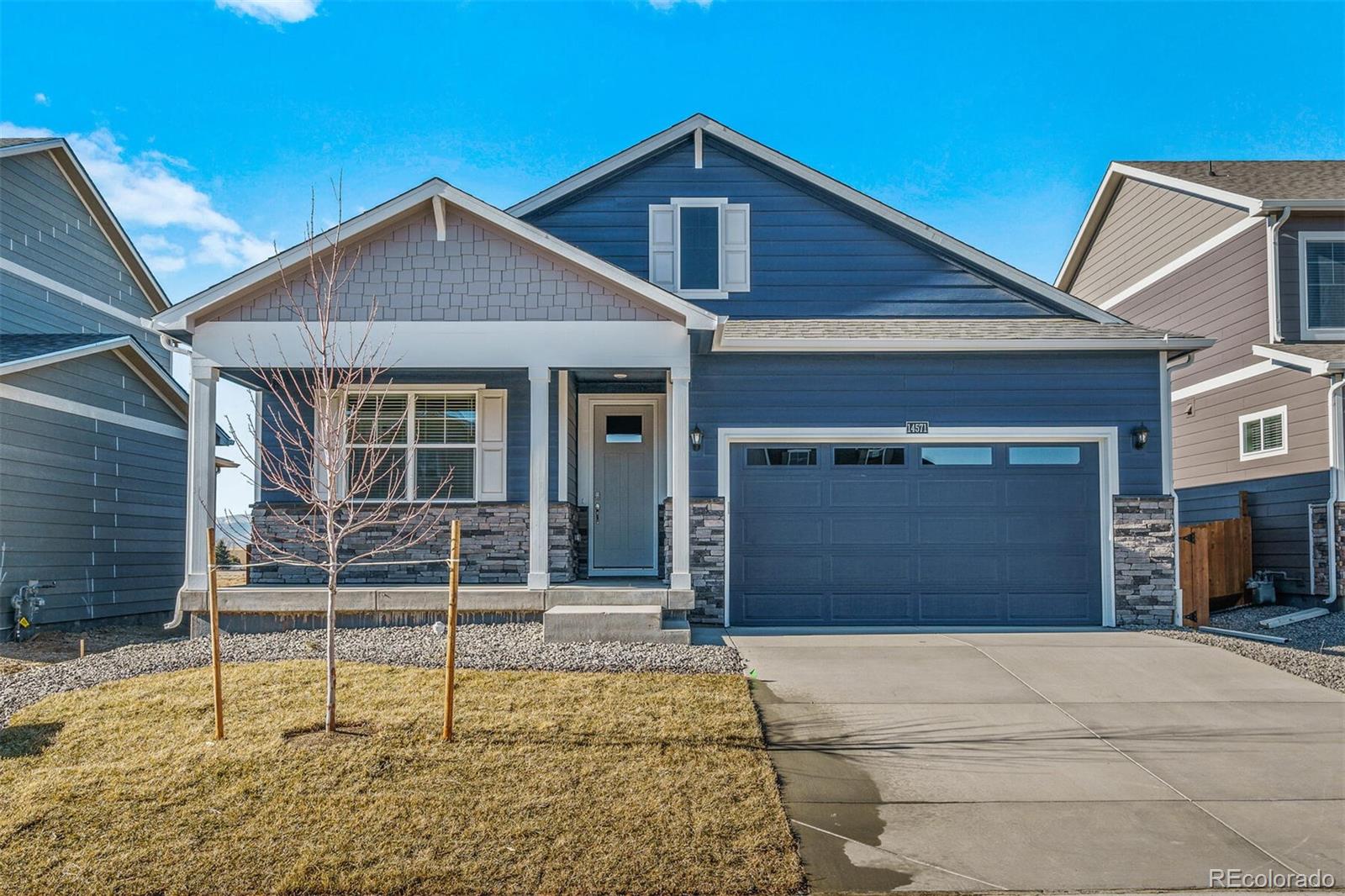 a front view of a house with garage