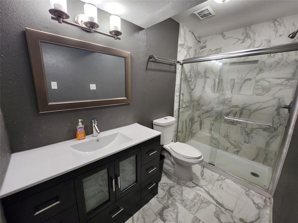 a bathroom with a double vanity sink toilet and a mirror