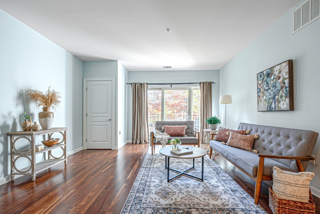 a living room with furniture and wooden floor