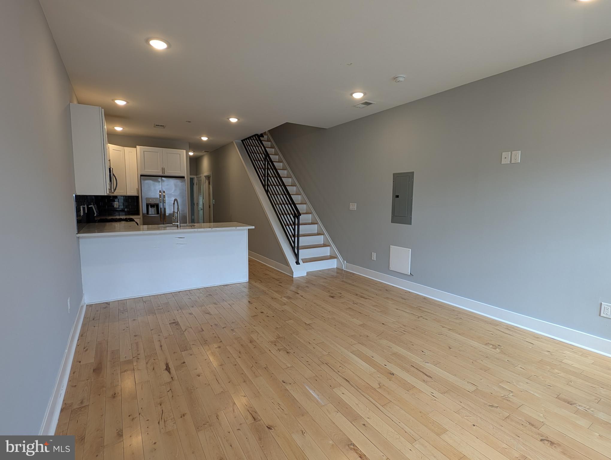 a view of an empty room with wooden floor