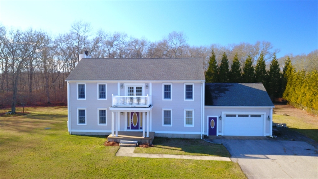 a aerial view of a house with swimming pool in front of it