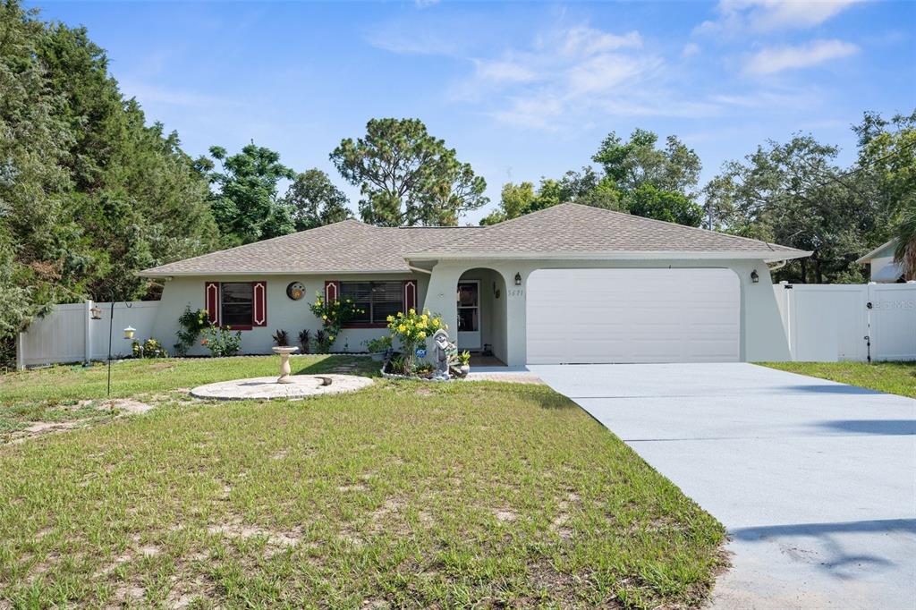 a front view of a house with yard and green space