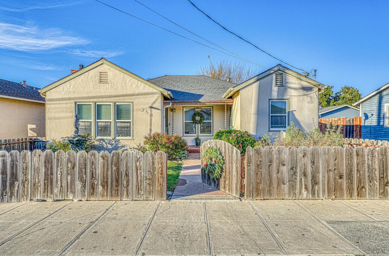 a view of a house with wooden fence