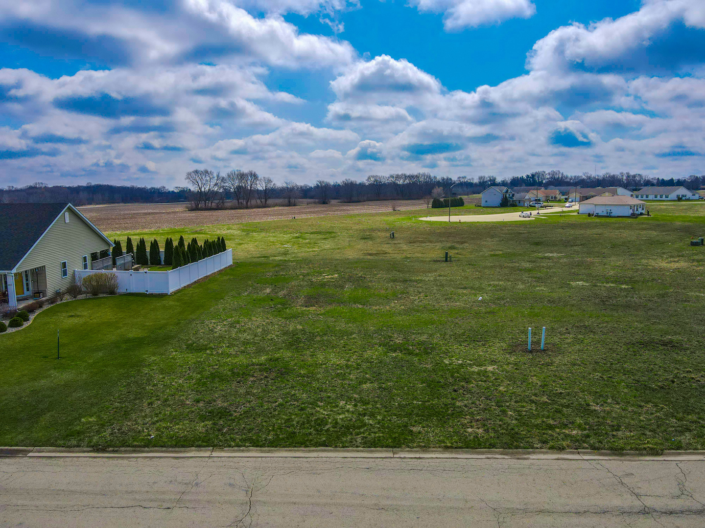 a view of a big yard with table and longer chairs