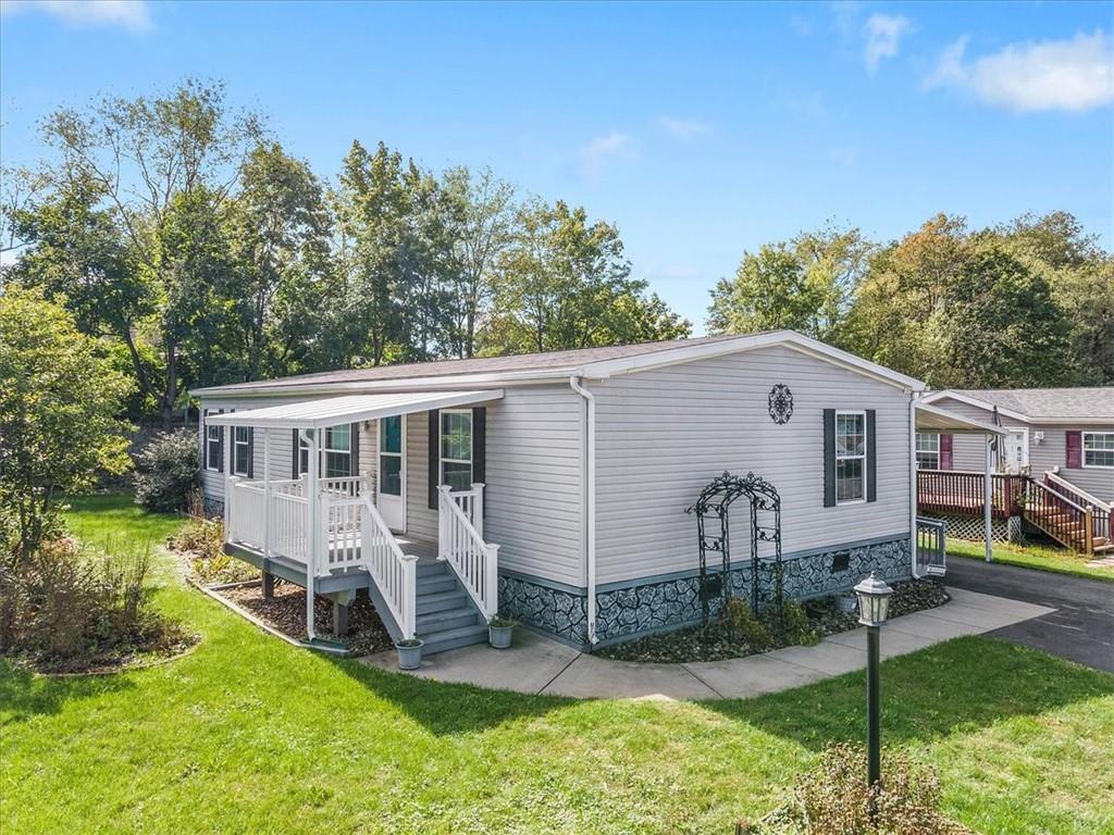 a view of a house with a yard patio and a small yard