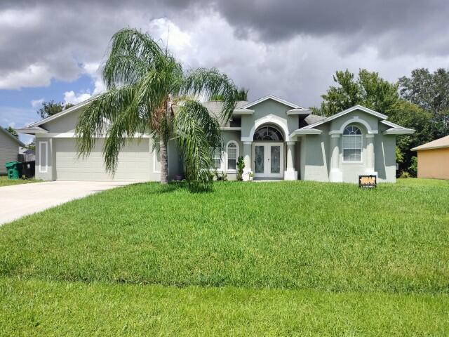 a front view of a house with a garden