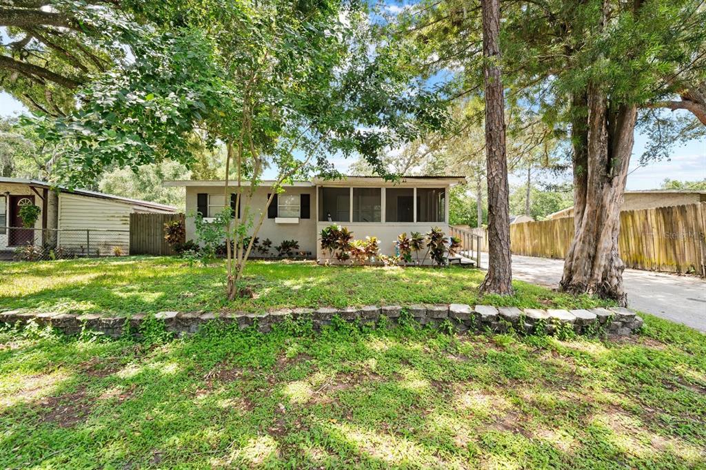 a front view of house with yard and green space