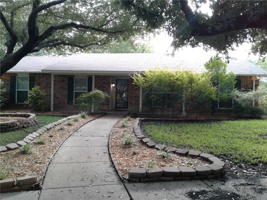 a view of a backyard with plants and patio