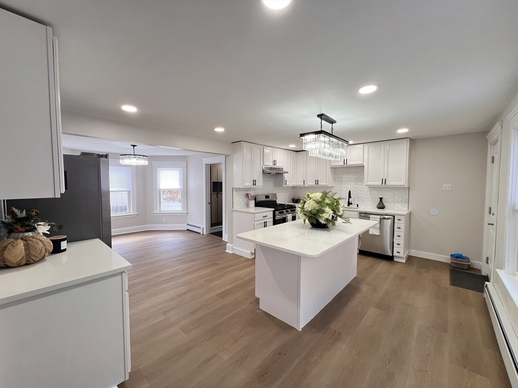 a kitchen with counter top space a sink cabinets and stainless steel appliances