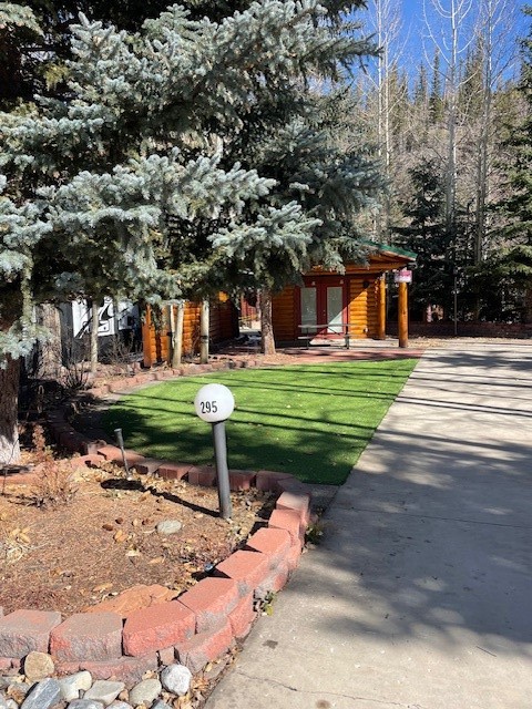 a front view of a house with a yard and trees