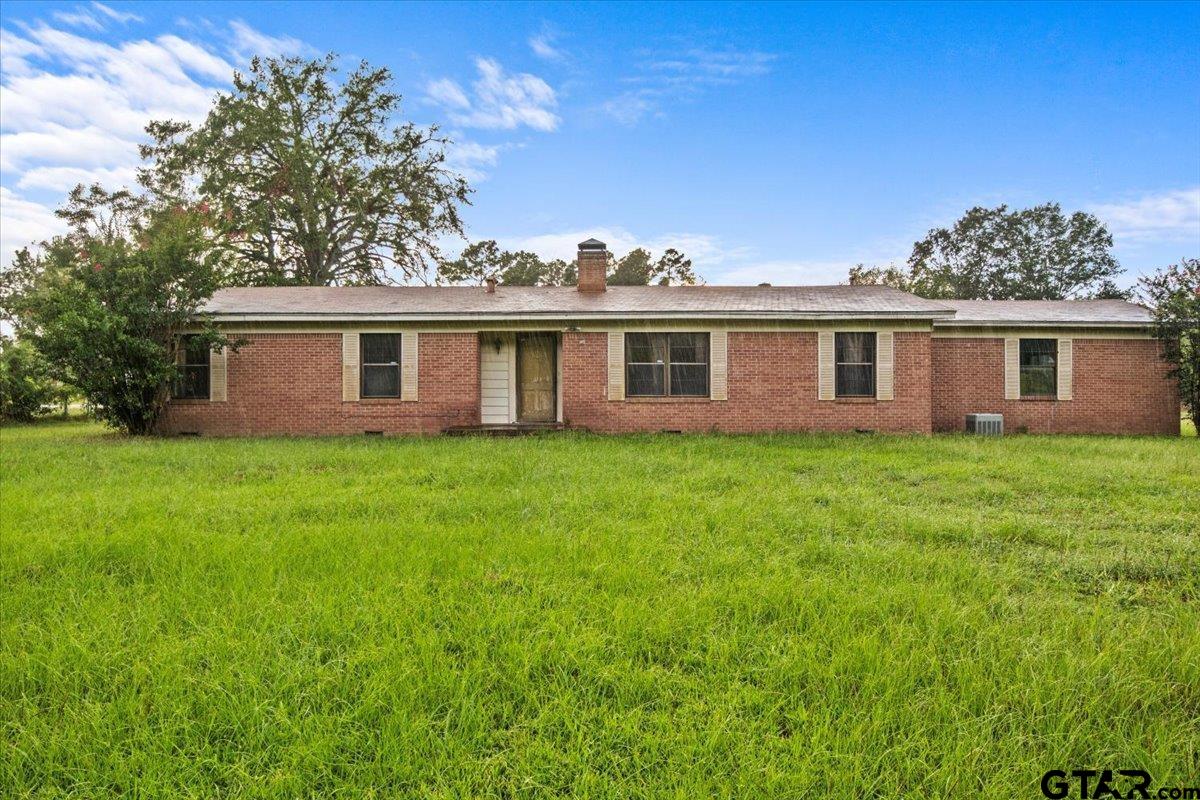 a view of a house with a backyard space