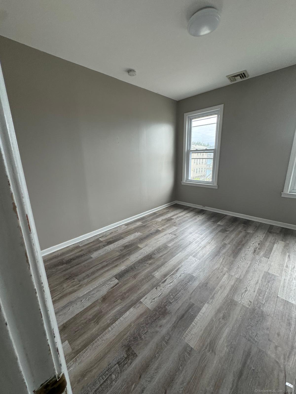 a view of room with window and hardwood floor