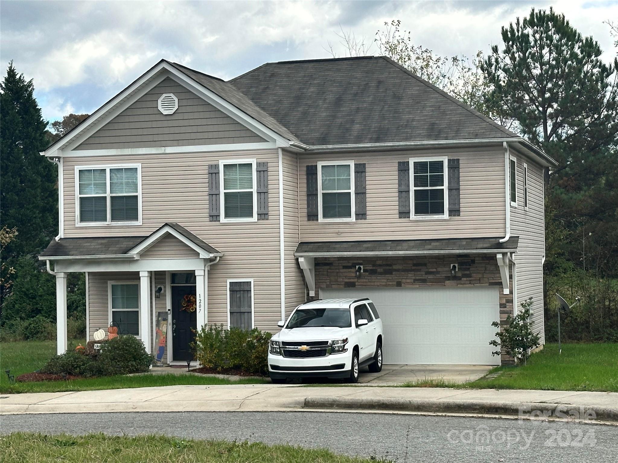 a front view of a house with a yard