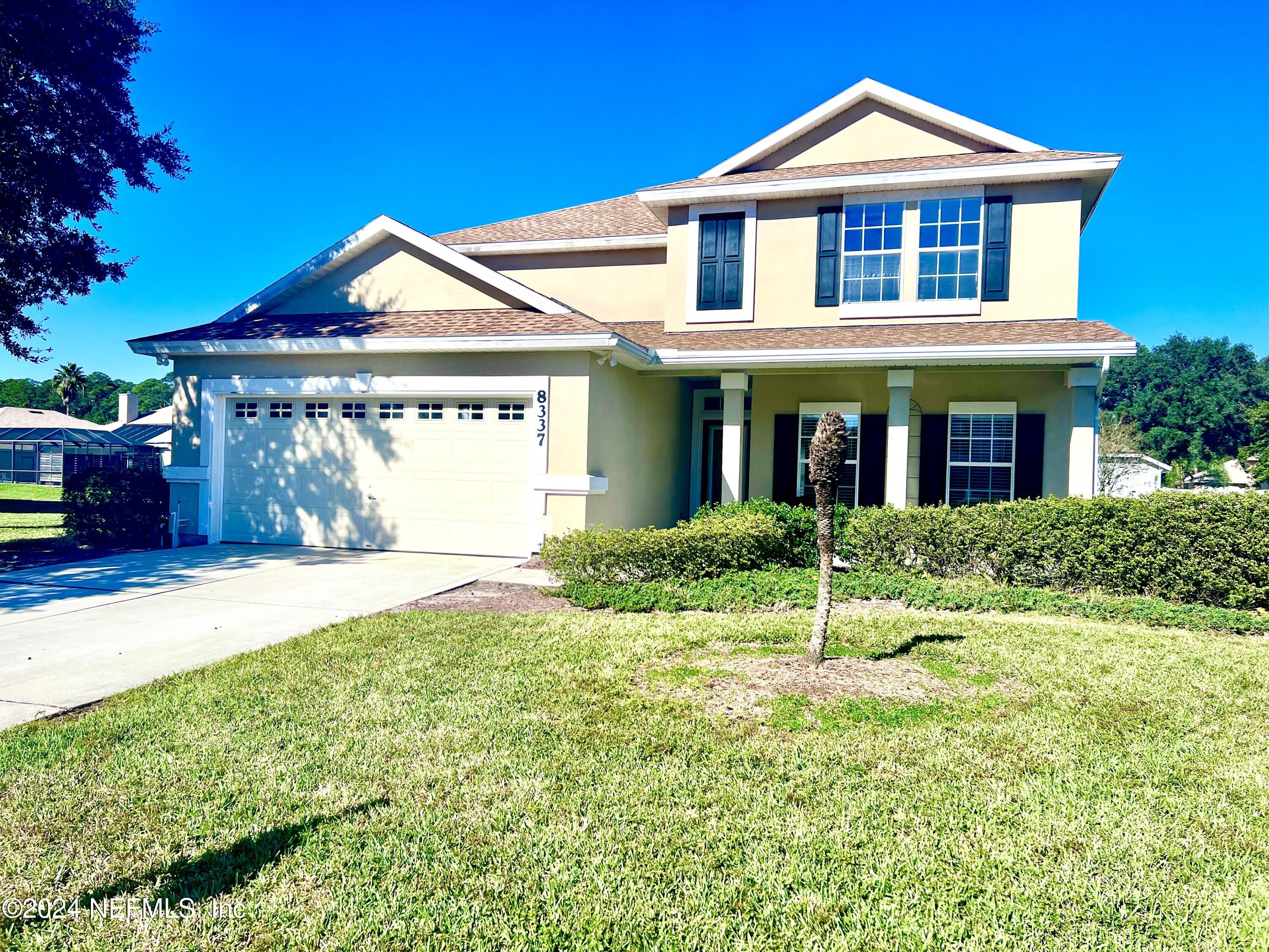 a view of a house with a yard