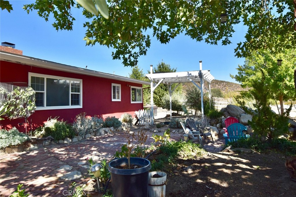 a view of a house with a yard and garden