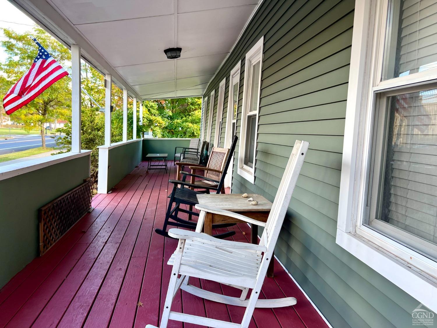 a view of balcony with furniture and wooden floor