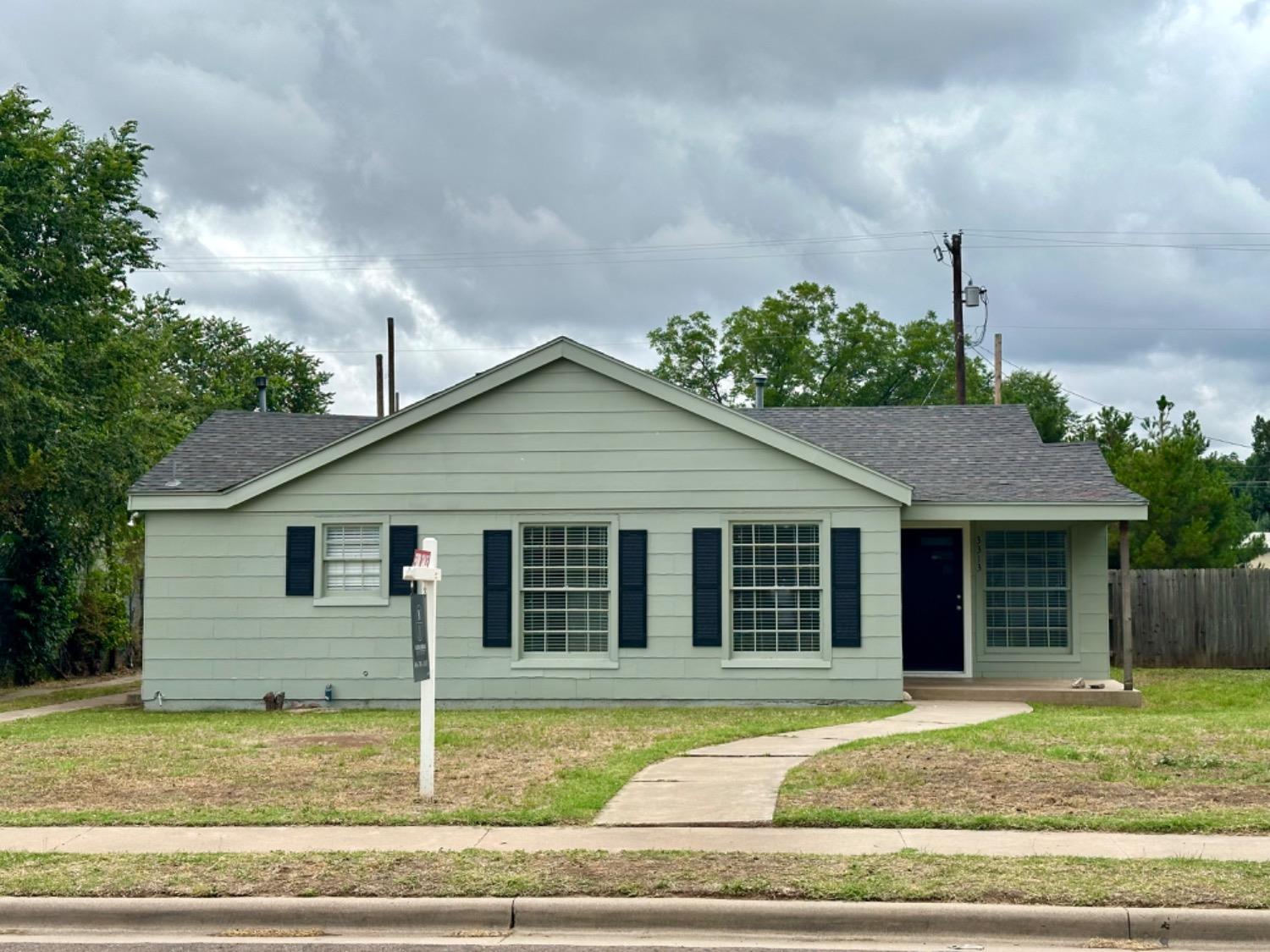 a house that has a tree in front of it