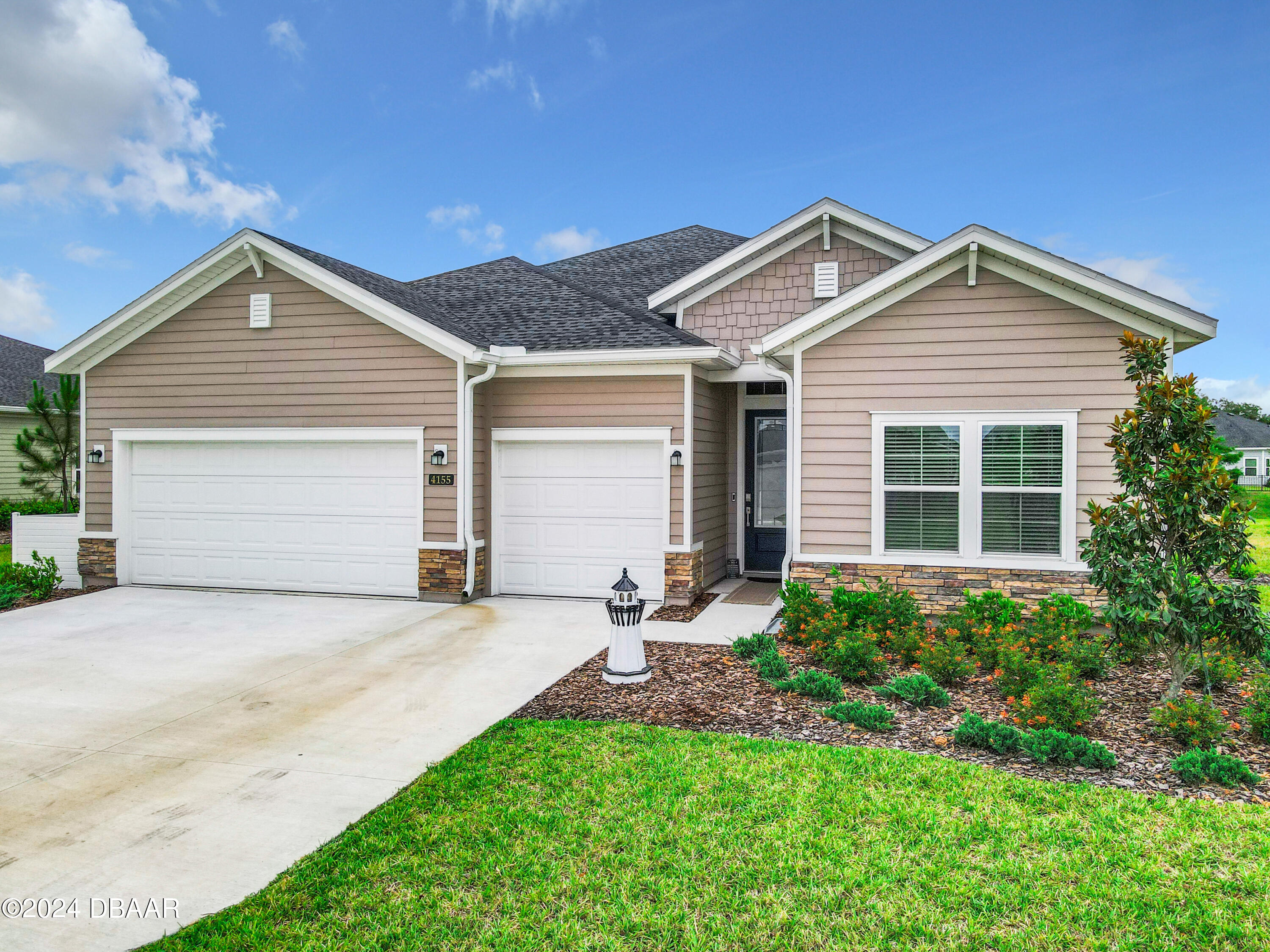 a front view of a house with a yard and garage