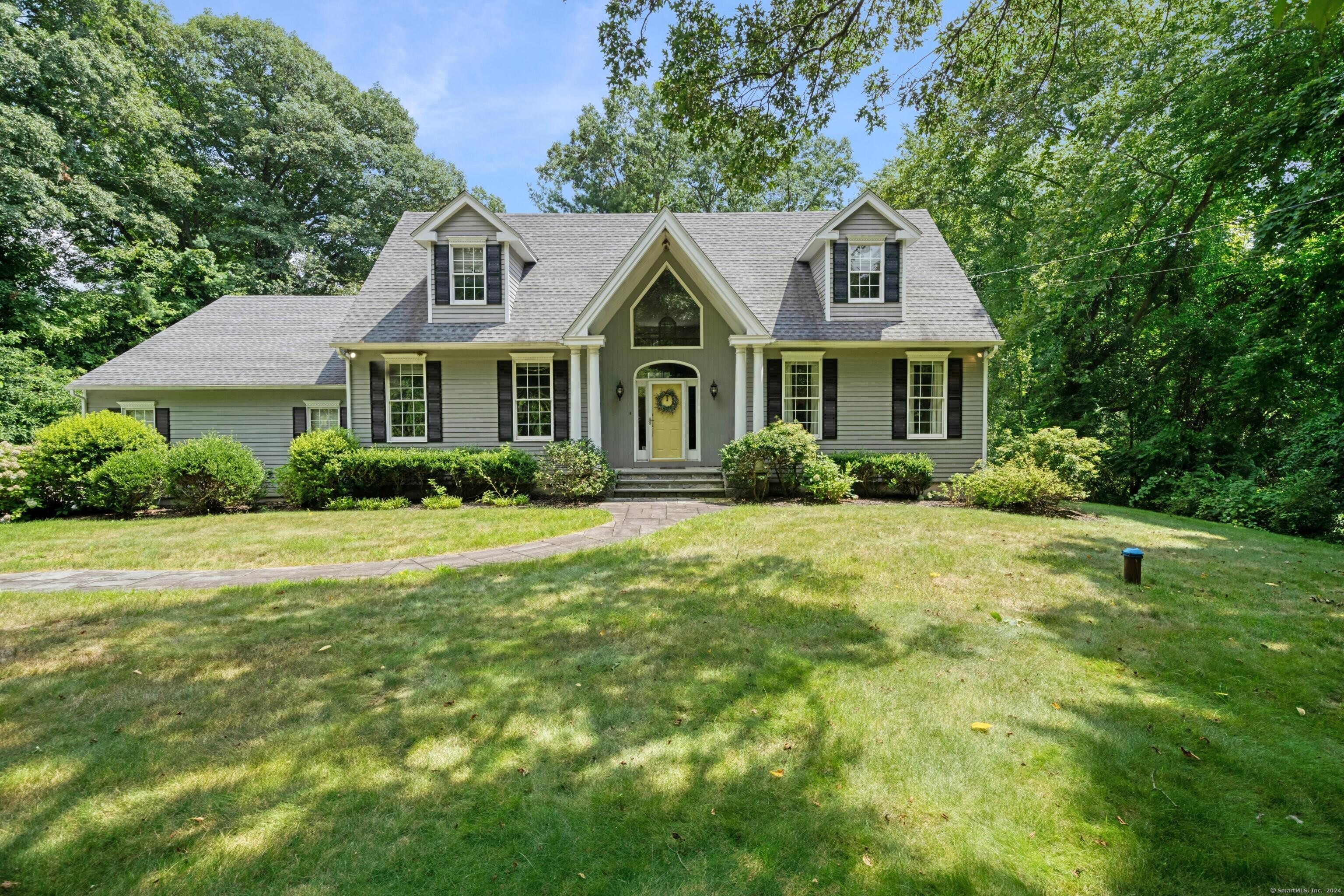 a front view of a house with a garden