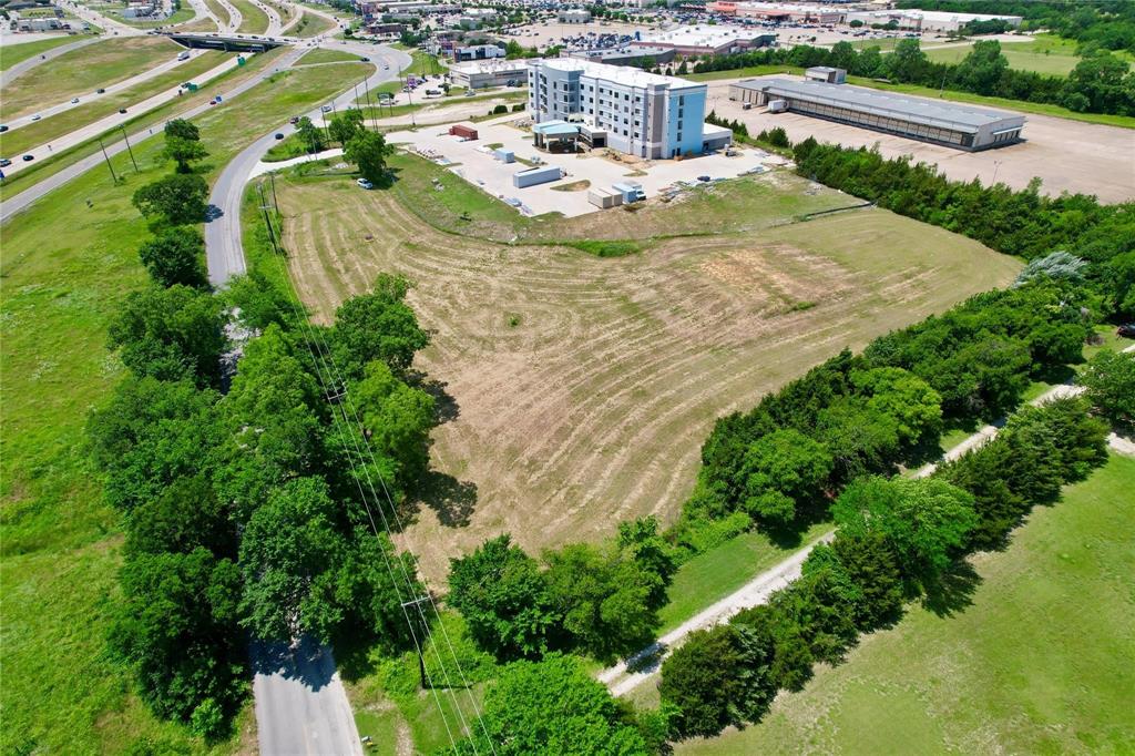 an aerial view of a house with a yard and lake view