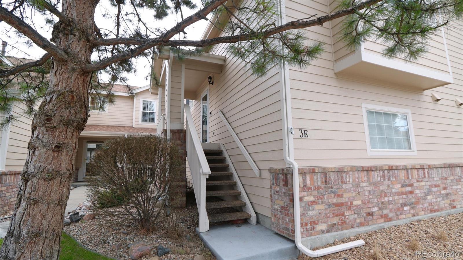 a view of a house with a tree