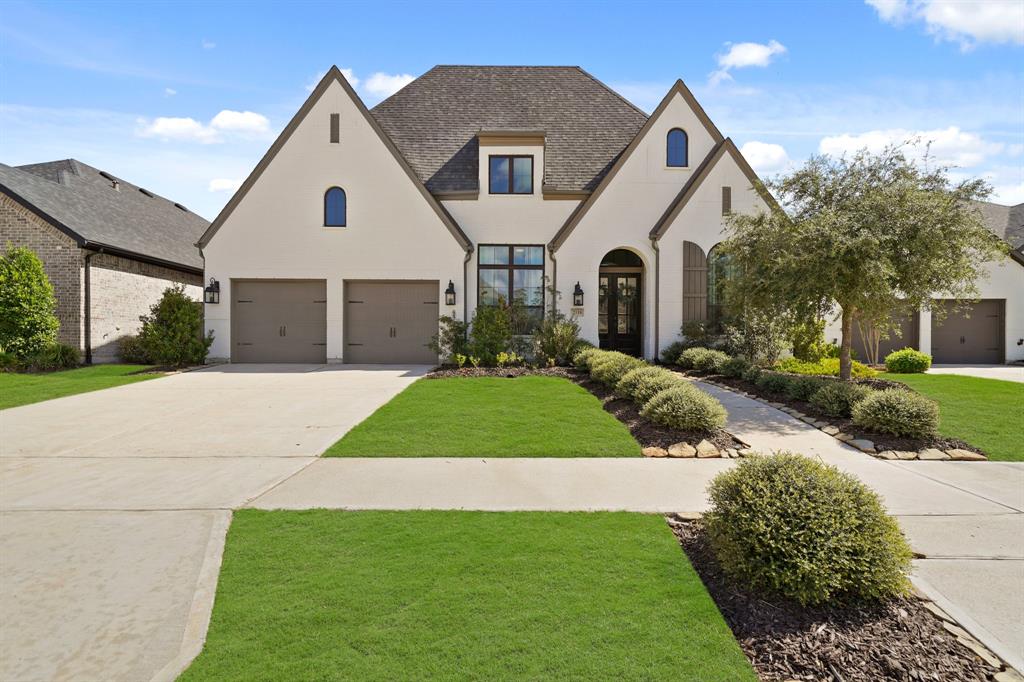 a front view of a house with a yard and garage