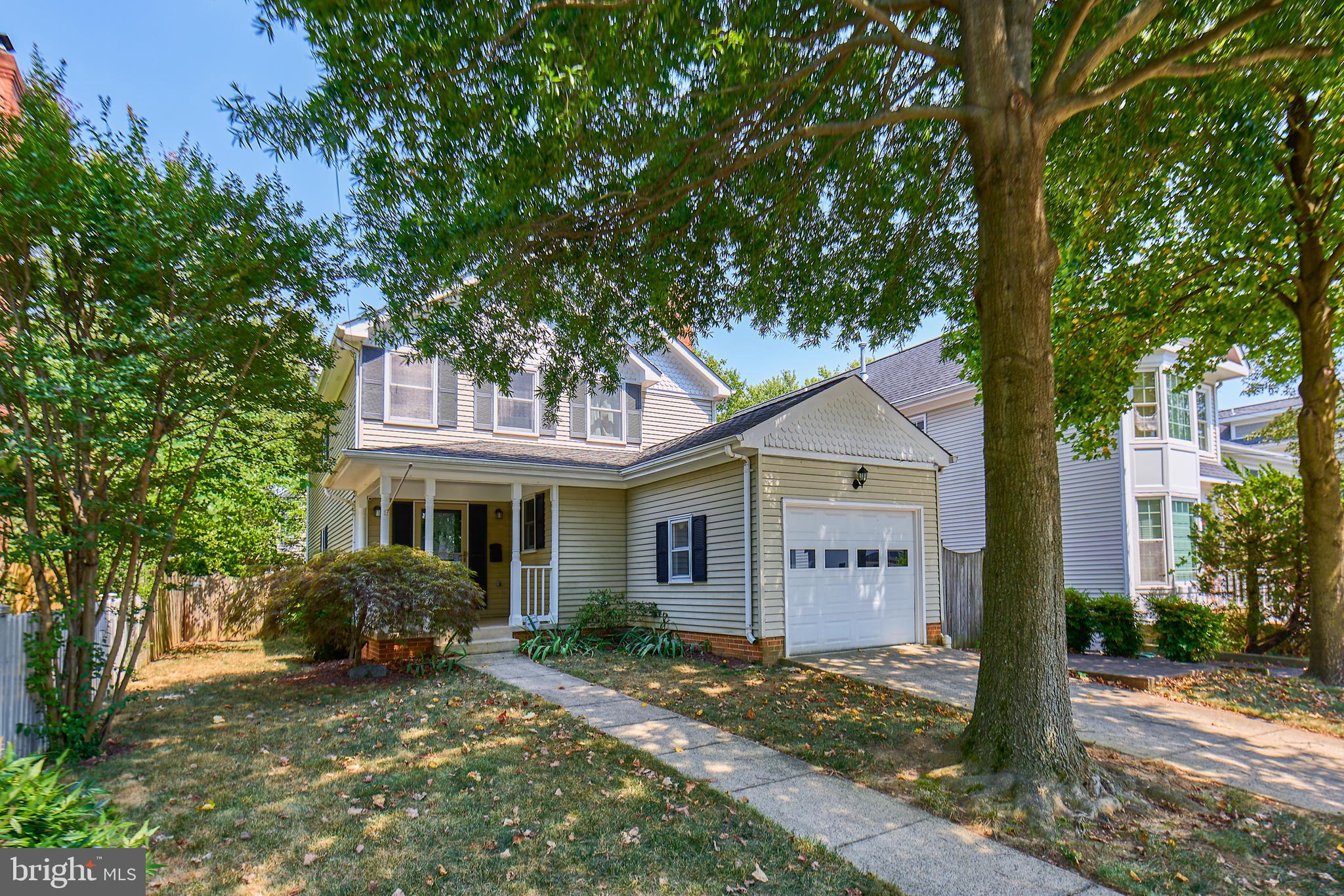 a view of a house with a tree in front of it