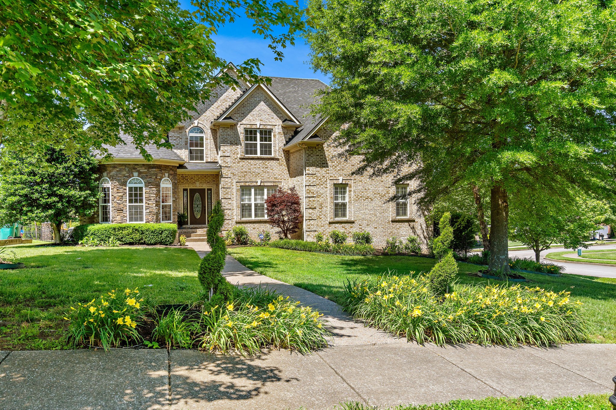 a front view of a house with a yard