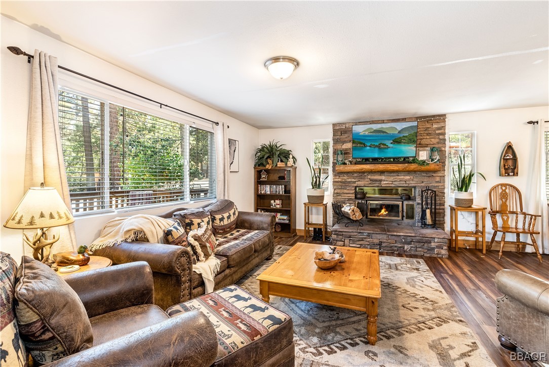 a living room with furniture large window and a fireplace