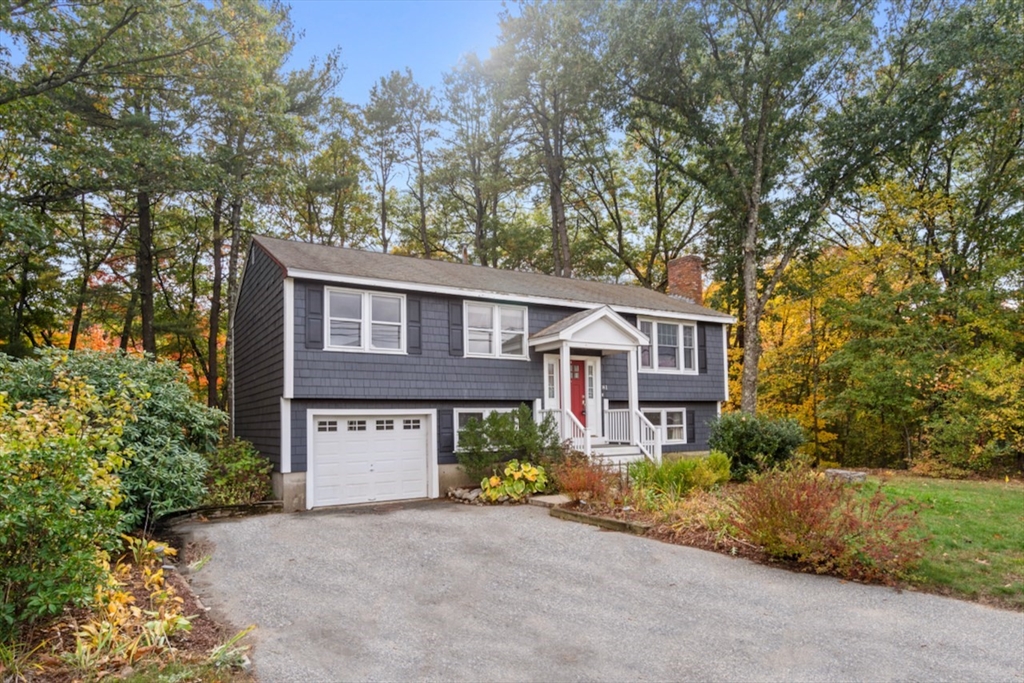 a view of a house with a tree and a yard