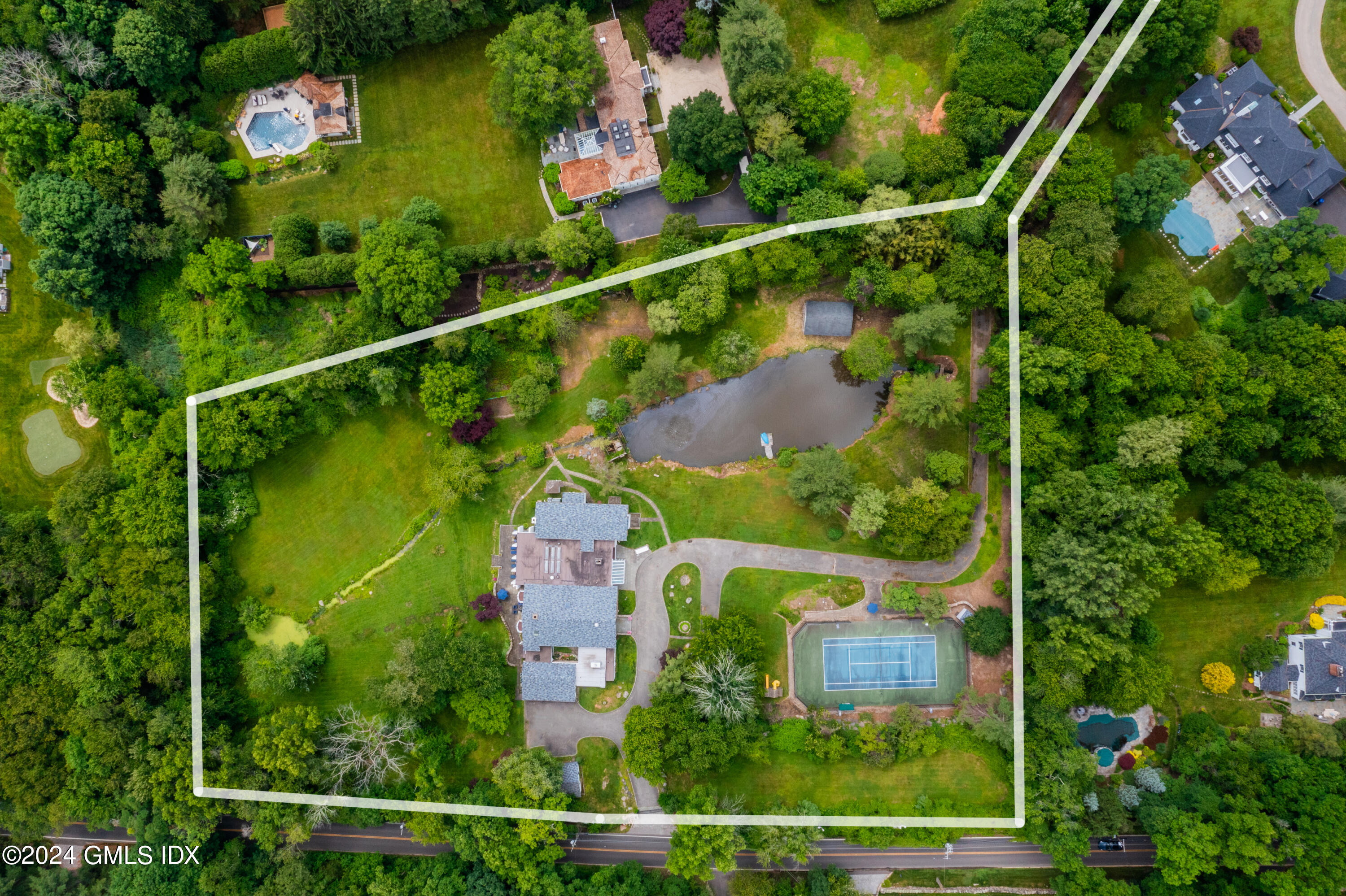 an aerial view of house with swimming pool outdoor seating and yard