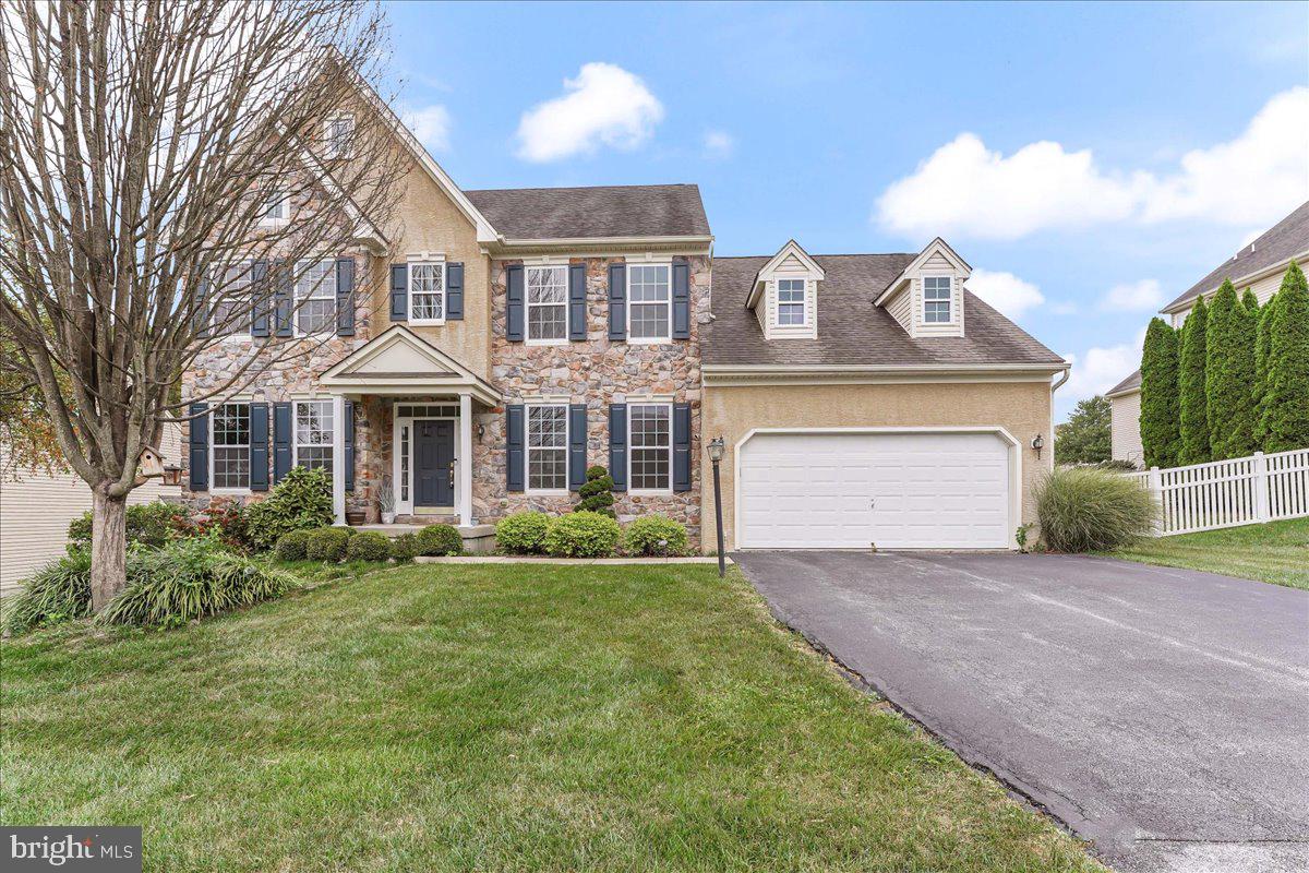 a front view of a house with a yard and garage