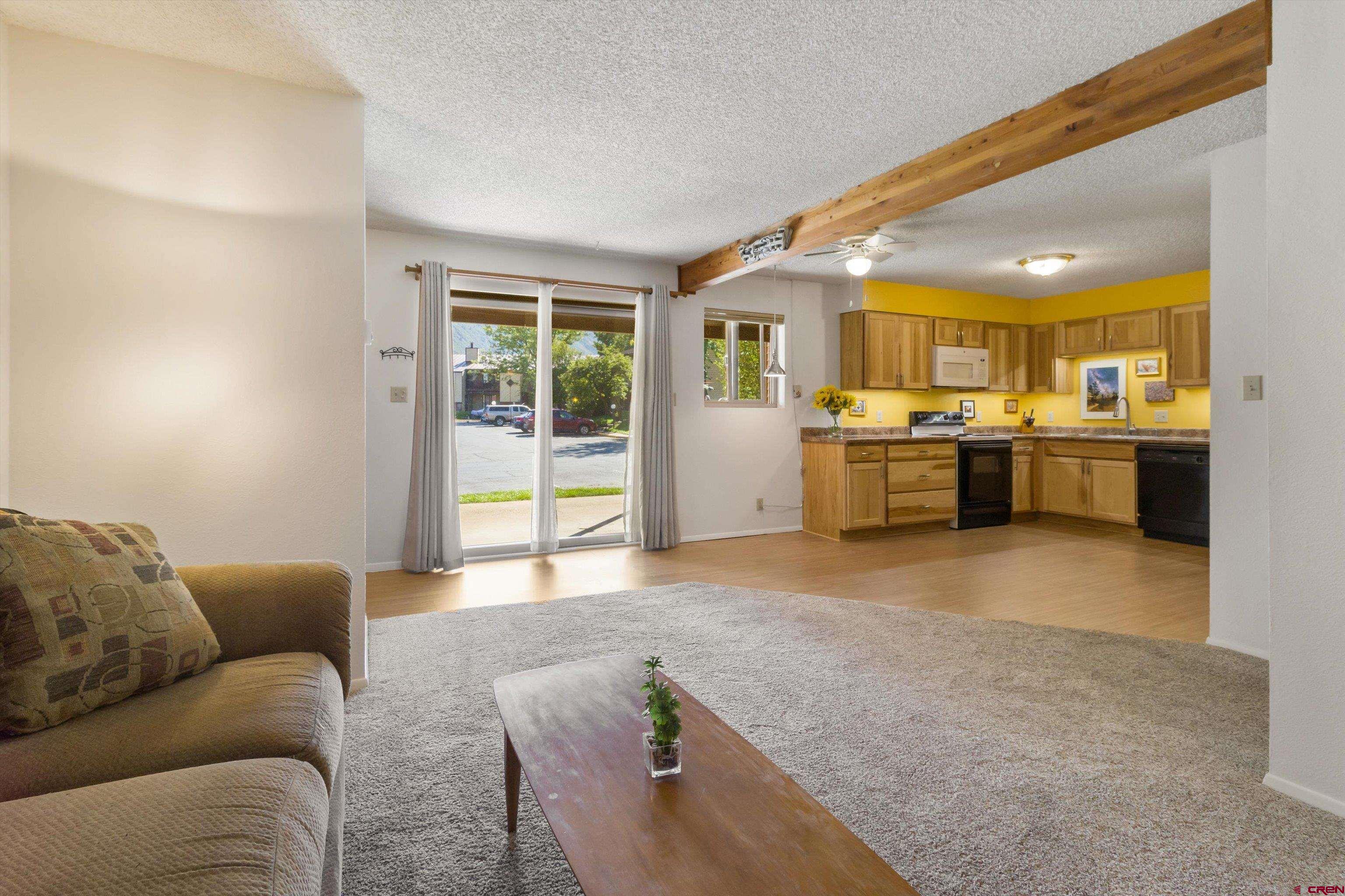 a living room with stainless steel appliances granite countertop lots of counter top space