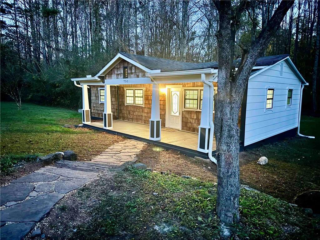 a view of a house with yard and tree s