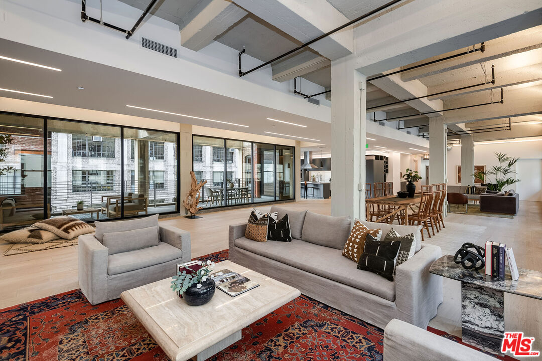 a living room with furniture ceiling fan and a rug