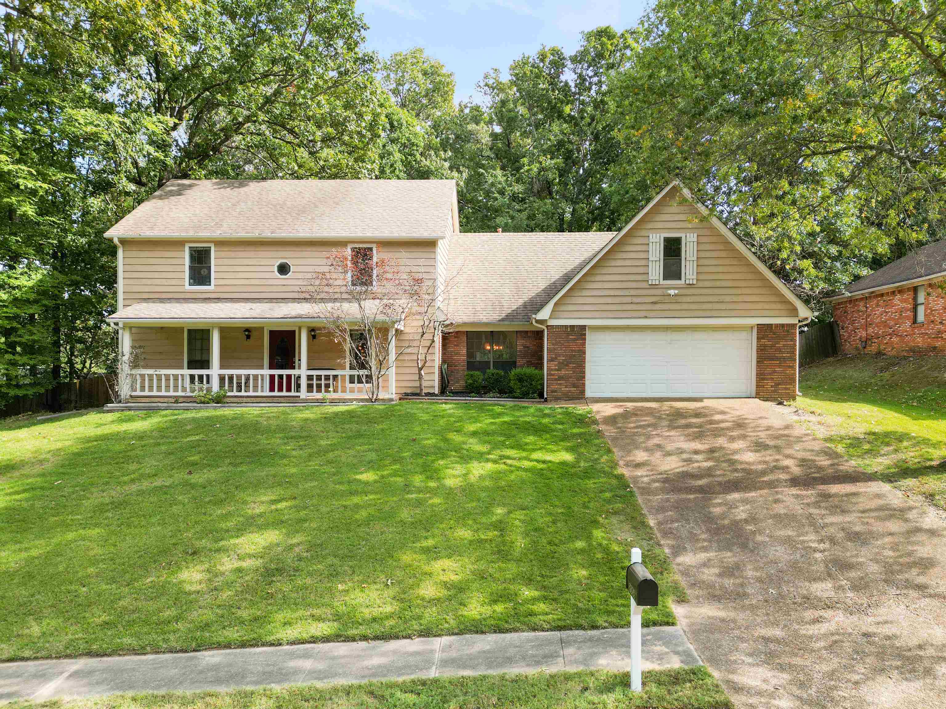 View of front of property with a front yard and a porch