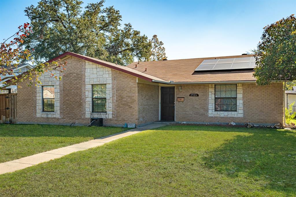 a backyard of a house with large trees and brick walls