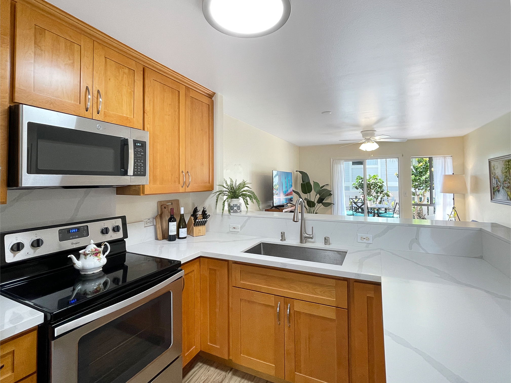 a kitchen with stainless steel appliances a stove sink microwave and cabinets