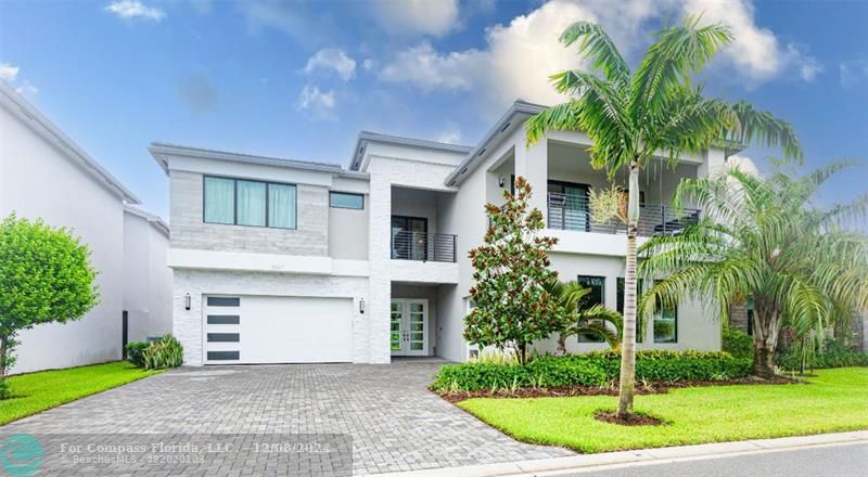 a front view of a house with a garden and trees