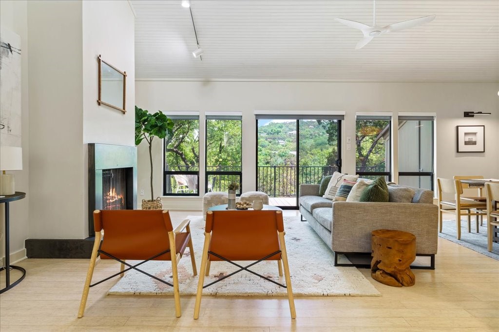 a living room with furniture and a floor to ceiling window