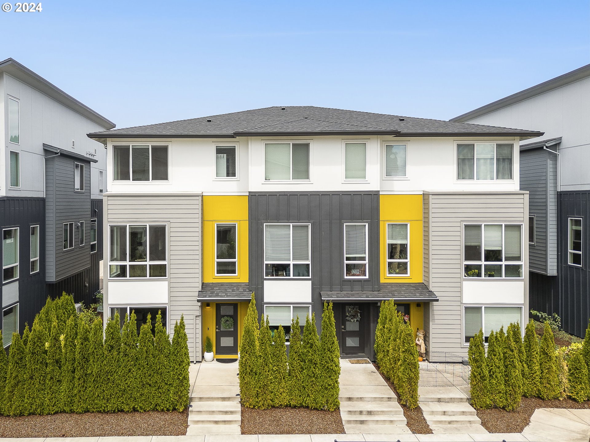 a front view of a residential apartment building with a yard