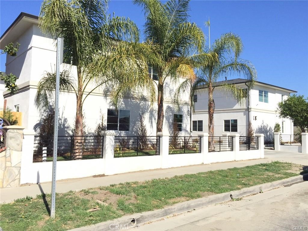 a view of a white house with a yard