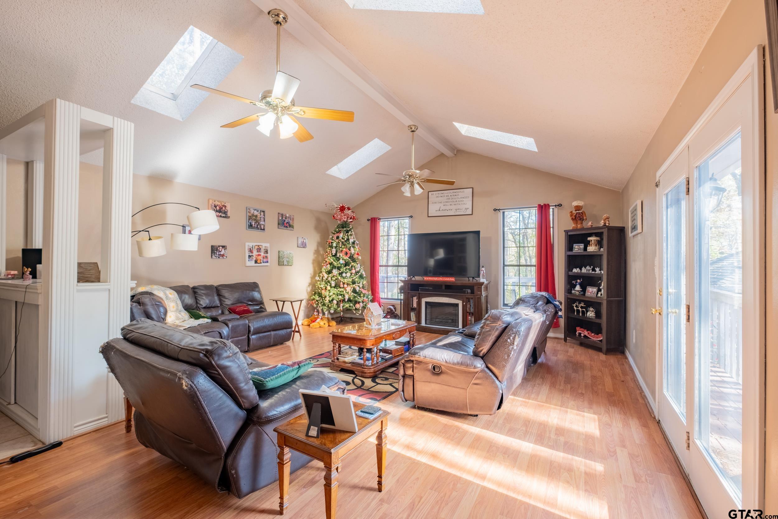 a living room with furniture a fireplace and a window