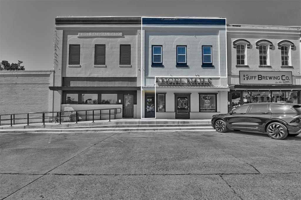 a view of a car parked in front of a building