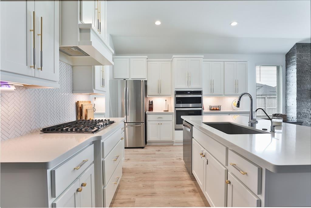 a kitchen with a sink stove and refrigerator