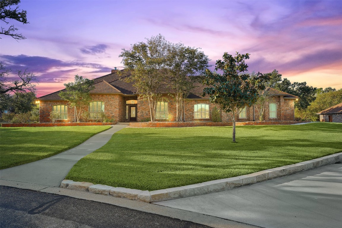 a front view of a house with a yard