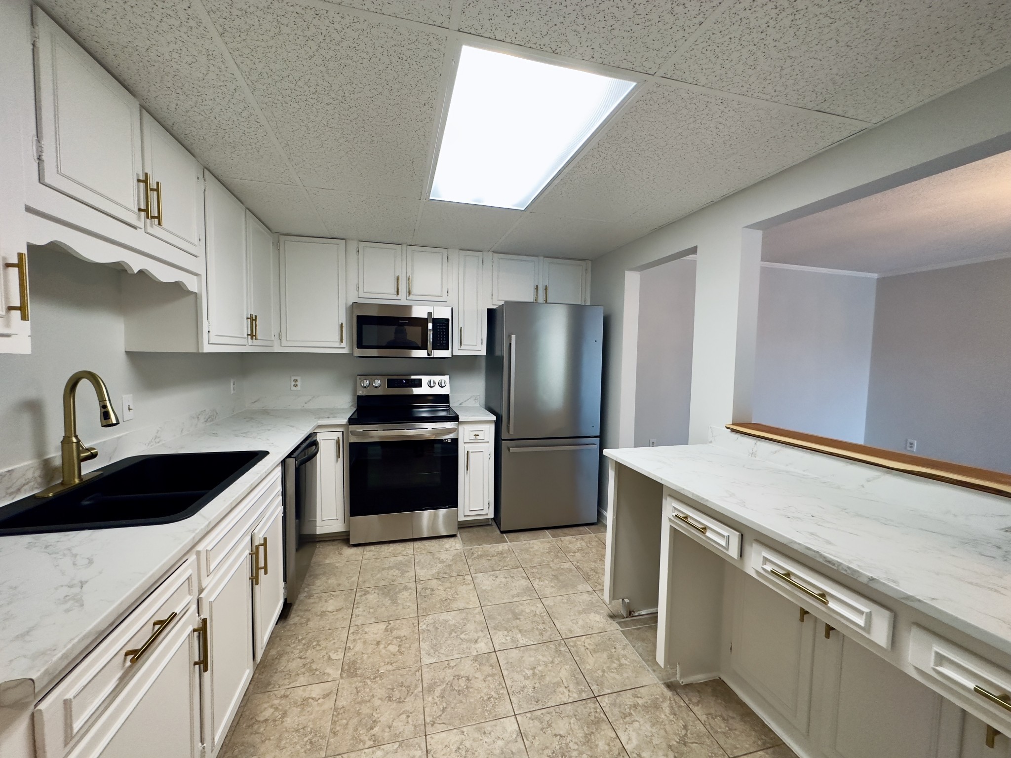 a kitchen with a sink stove and refrigerator