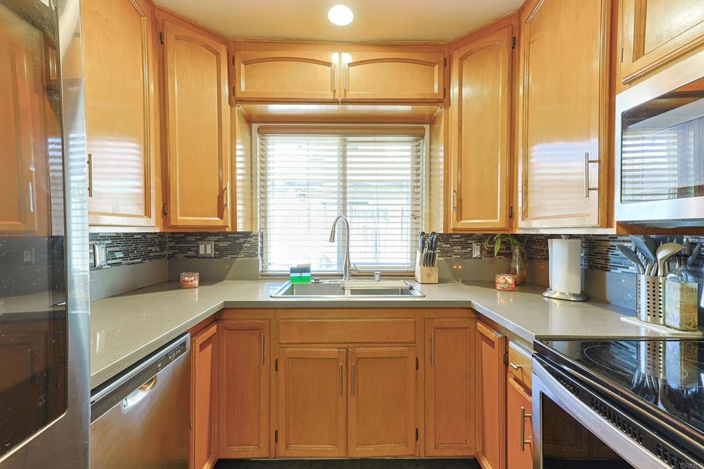 a kitchen with granite countertop a sink and a window