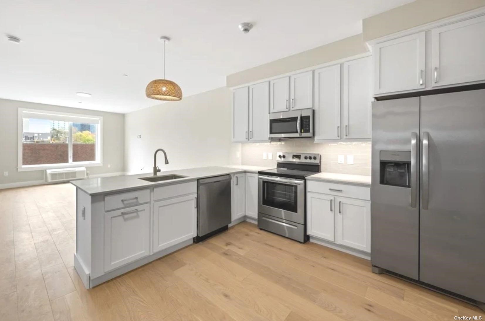 a kitchen with granite countertop a refrigerator oven a sink and dishwasher