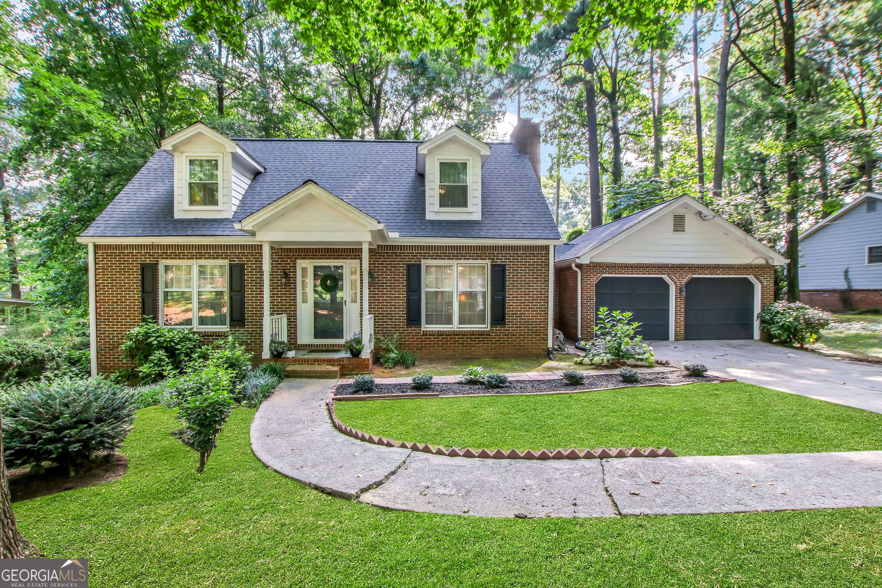 a front view of a house with a yard and porch